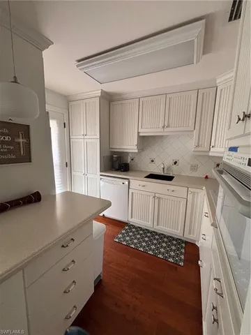 a kitchen with stainless steel appliances a stove a sink and a refrigerator