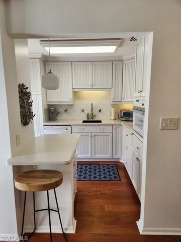 a kitchen with a sink a stove and cabinets