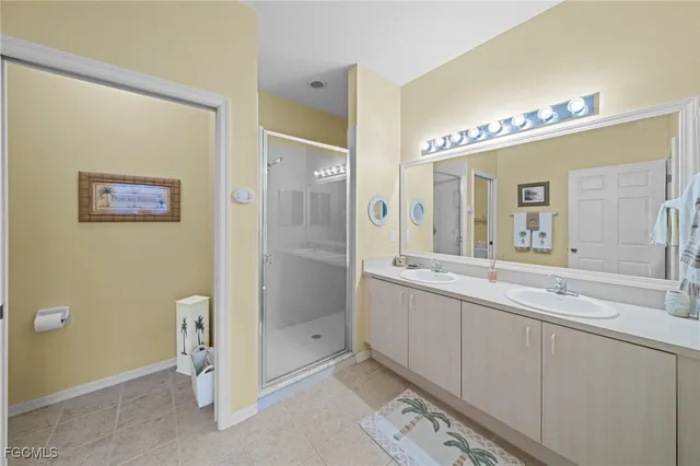 a bathroom with a double vanity sink and a mirror