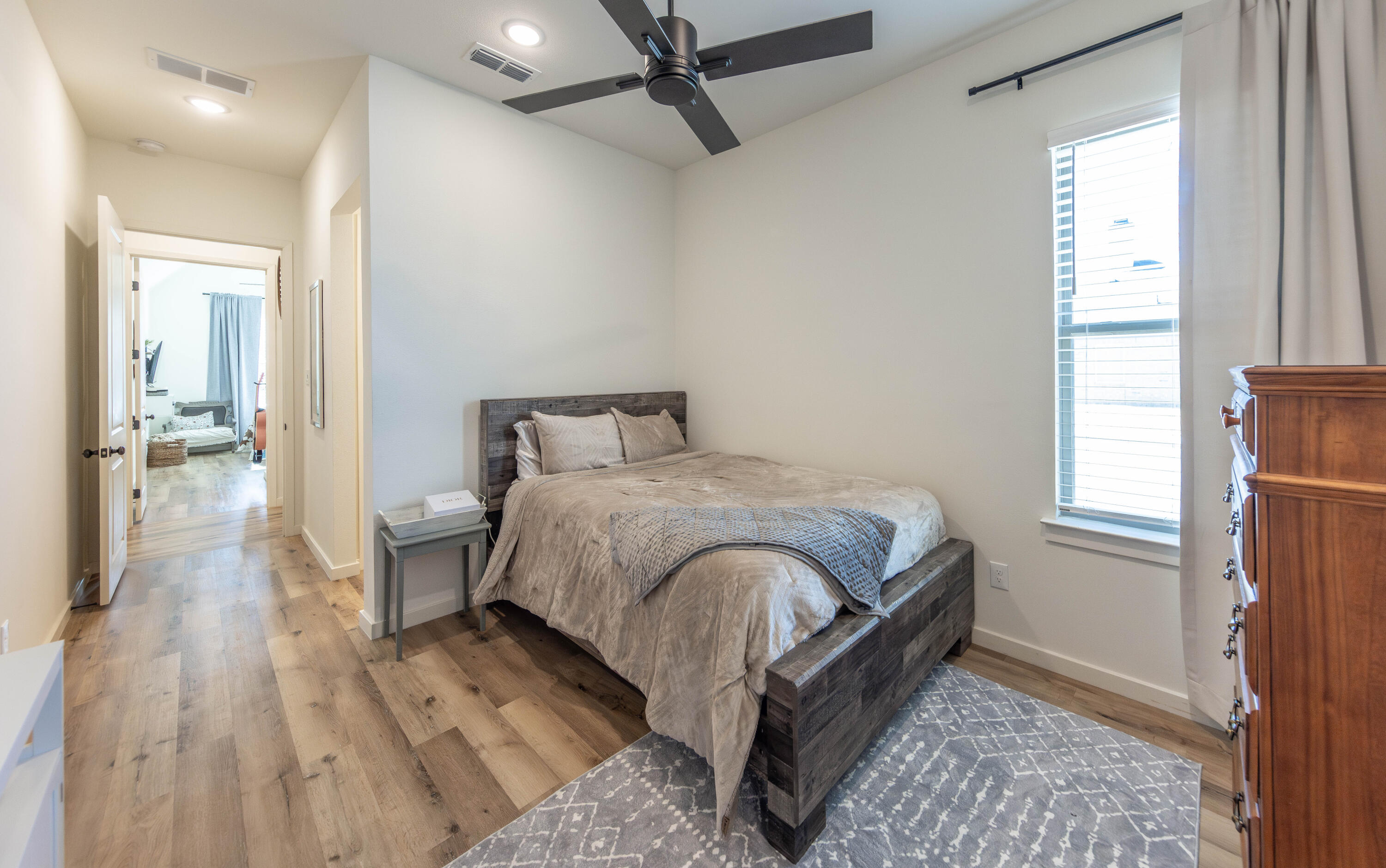 3816 128th Street Lubbock, TX 79423 - Photo 28 of 47 a bedroom with a bed and wooden floor