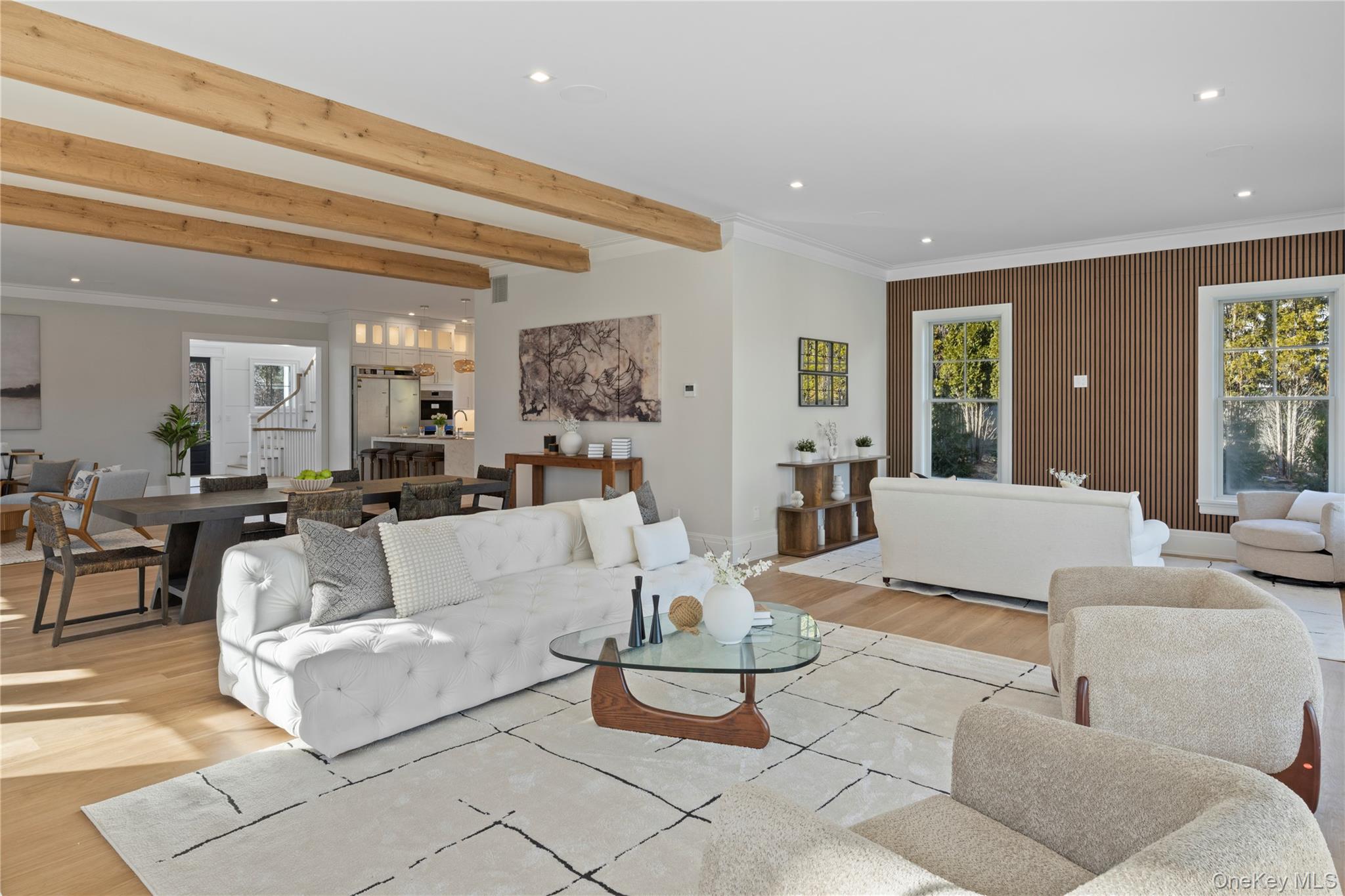 2590 Cox Neck Road Mattituck, NY 11952 - Photo 11 of 50 A sophisticated gathering space where modern design meets coastal serenity, highlighted by panoramic water views and architectural scale