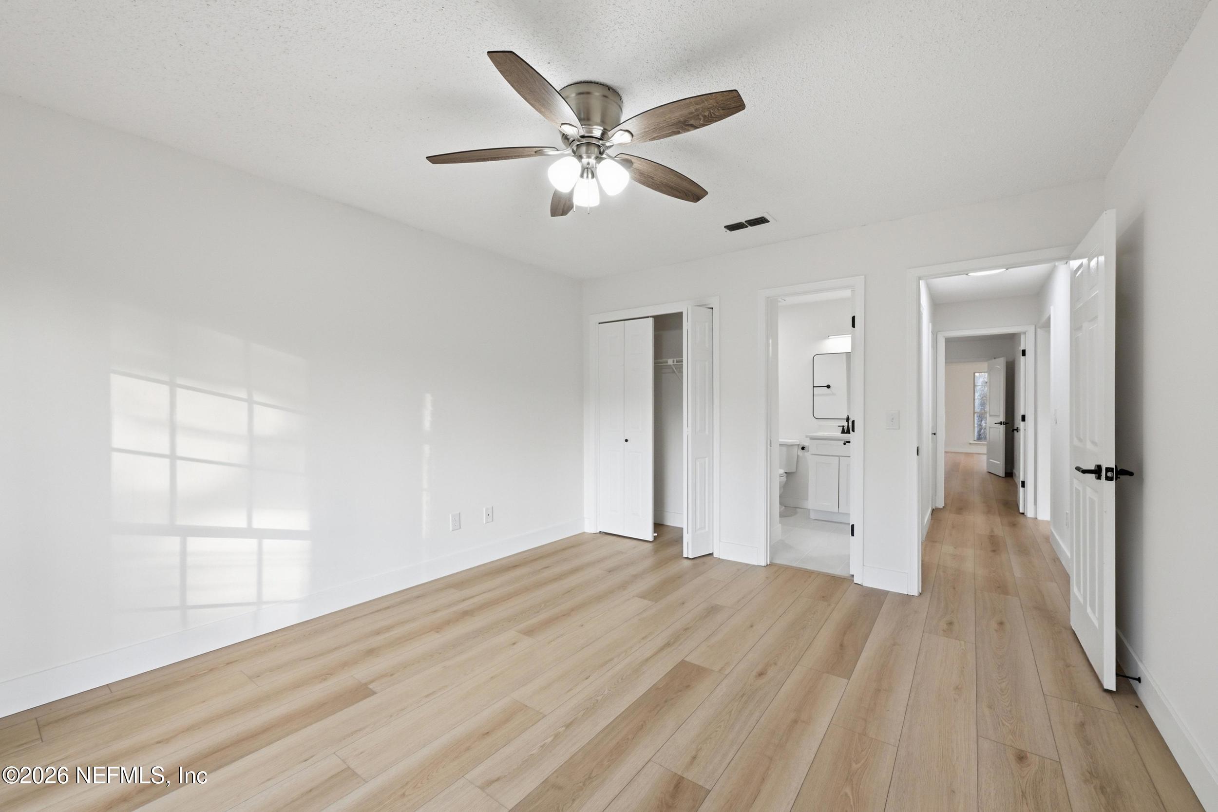 3286 Marbon Road Jacksonville, FL 32223 - Photo 20 of 36 a view of empty room with wooden floor and ceiling fan