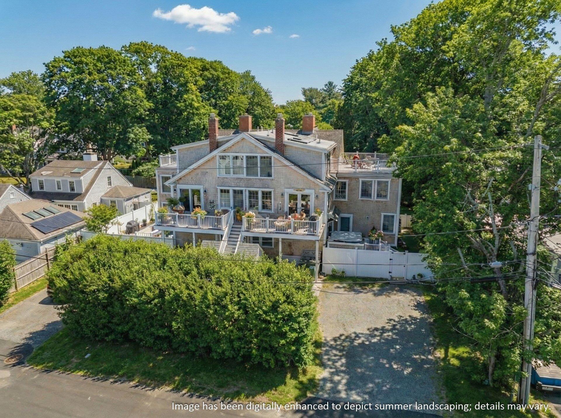 25 Main Street, Unit 3 Marion Center, MA 02738 - Photo 29 of 32 a front view of a house with a yard table and chairs