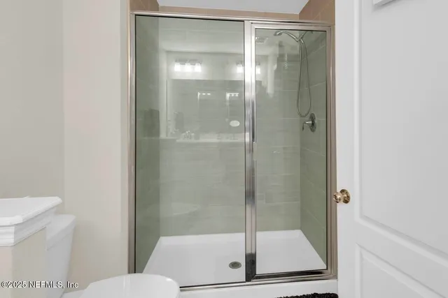 a bathroom with a glass shower door