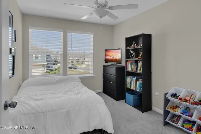 a bedroom with a bed and a book shelf