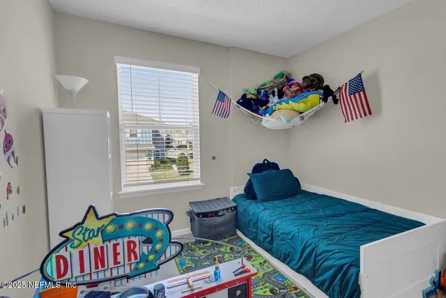 a bedroom with a bed and window
