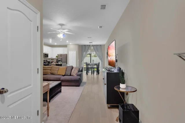 a living room with furniture and a mirror