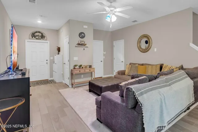 a bedroom with a bed and ceiling fan