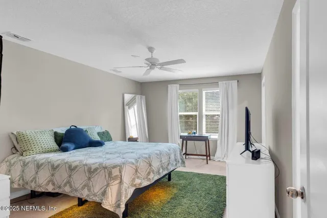 a bedroom with a bed and a large window