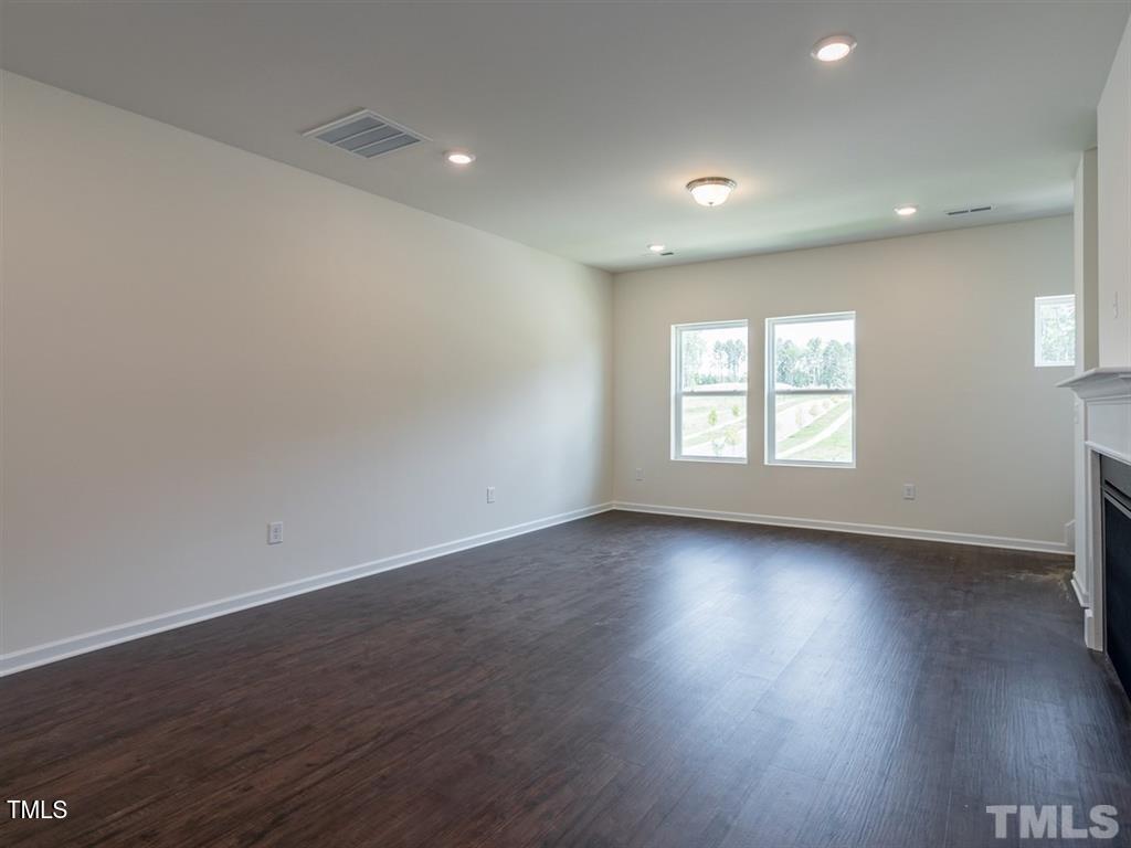 4035 Mahal Avenue Cary, NC 27519 - Photo 12 of 29 an empty room with wooden floor and window