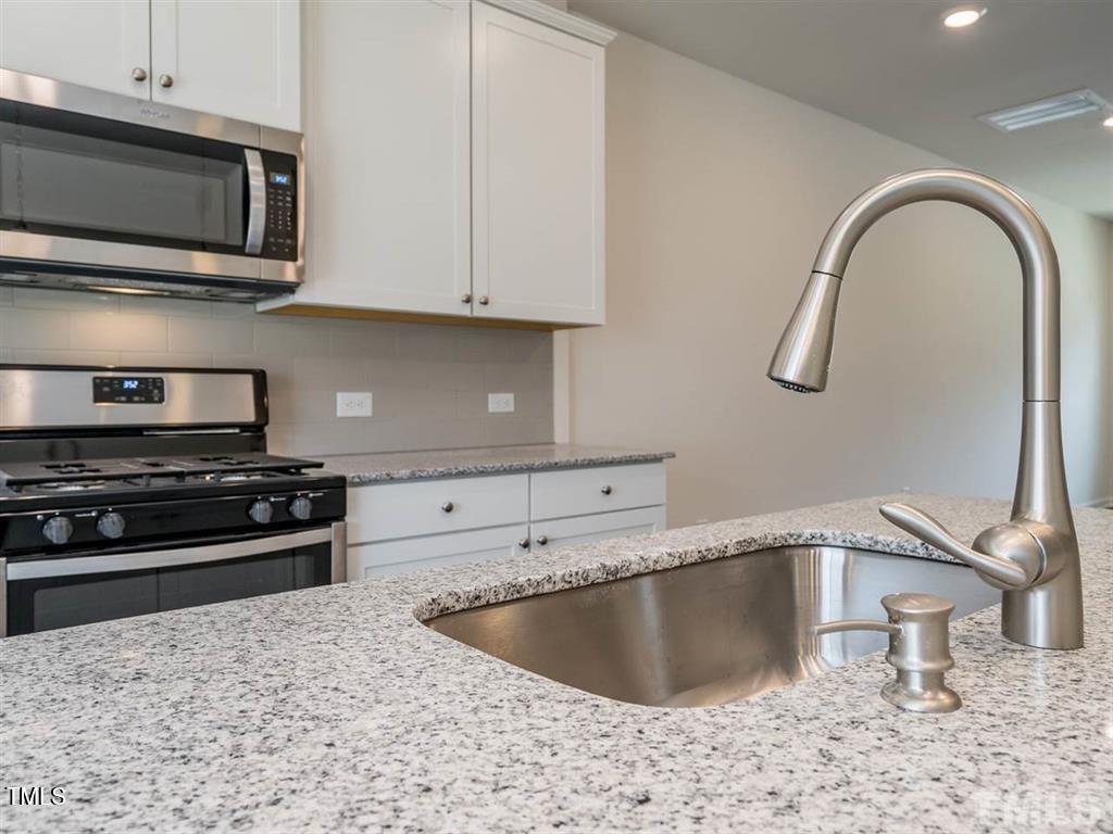 4035 Mahal Avenue Cary, NC 27519 - Photo 7 of 29 a kitchen with a stove and a microwave