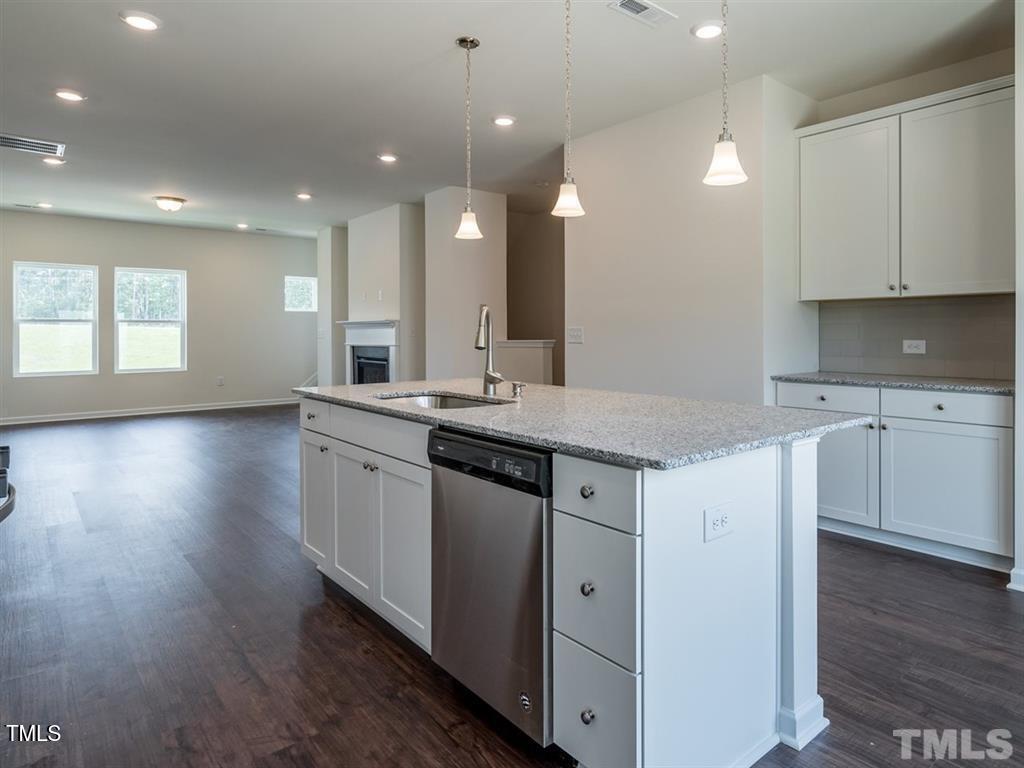 4035 Mahal Avenue Cary, NC 27519 - Photo 9 of 29 a kitchen with a sink stove and cabinets
