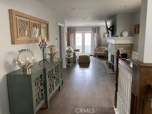 a view of a livingroom with furniture wooden floor windows and a chandelier