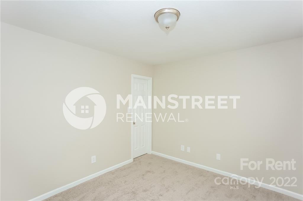 8566 Filbert Lane Charlotte, NC 28215 - Photo 13 of 32 a view of a room with racks on the wall