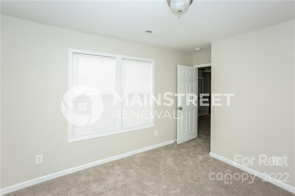 8566 Filbert Lane Charlotte, NC 28215 - Photo 14 of 32 an empty room with windows