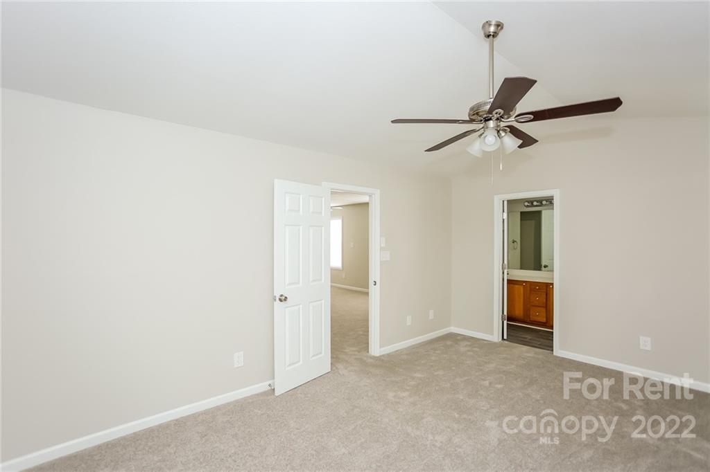 8566 Filbert Lane Charlotte, NC 28215 - Photo 25 of 32 a view of an empty room with a ceiling fan