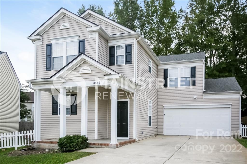 8566 Filbert Lane Charlotte, NC 28215 - Photo 5 of 32 a view of a white house with a small yard and a large tree
