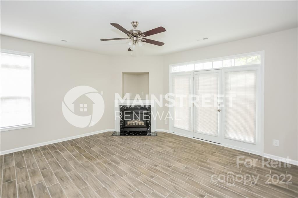 8566 Filbert Lane Charlotte, NC 28215 - Photo 6 of 32 a view of empty room with wooden floor and fan