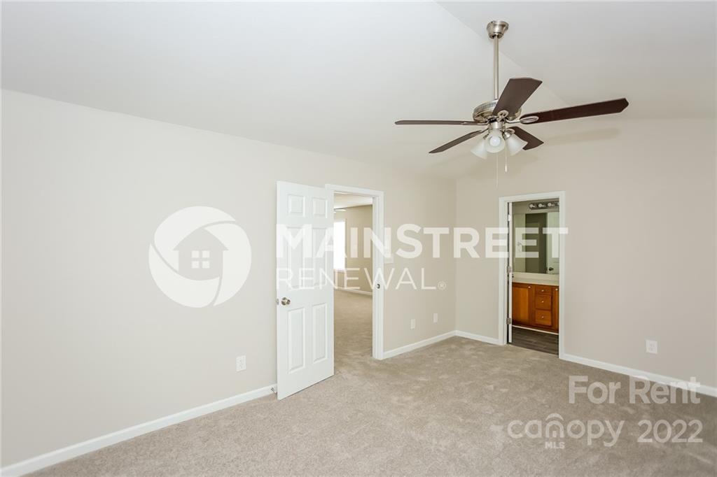 8566 Filbert Lane Charlotte, NC 28215 - Photo 10 of 32 a view of a livingroom with a chandelier fan and wooden floor