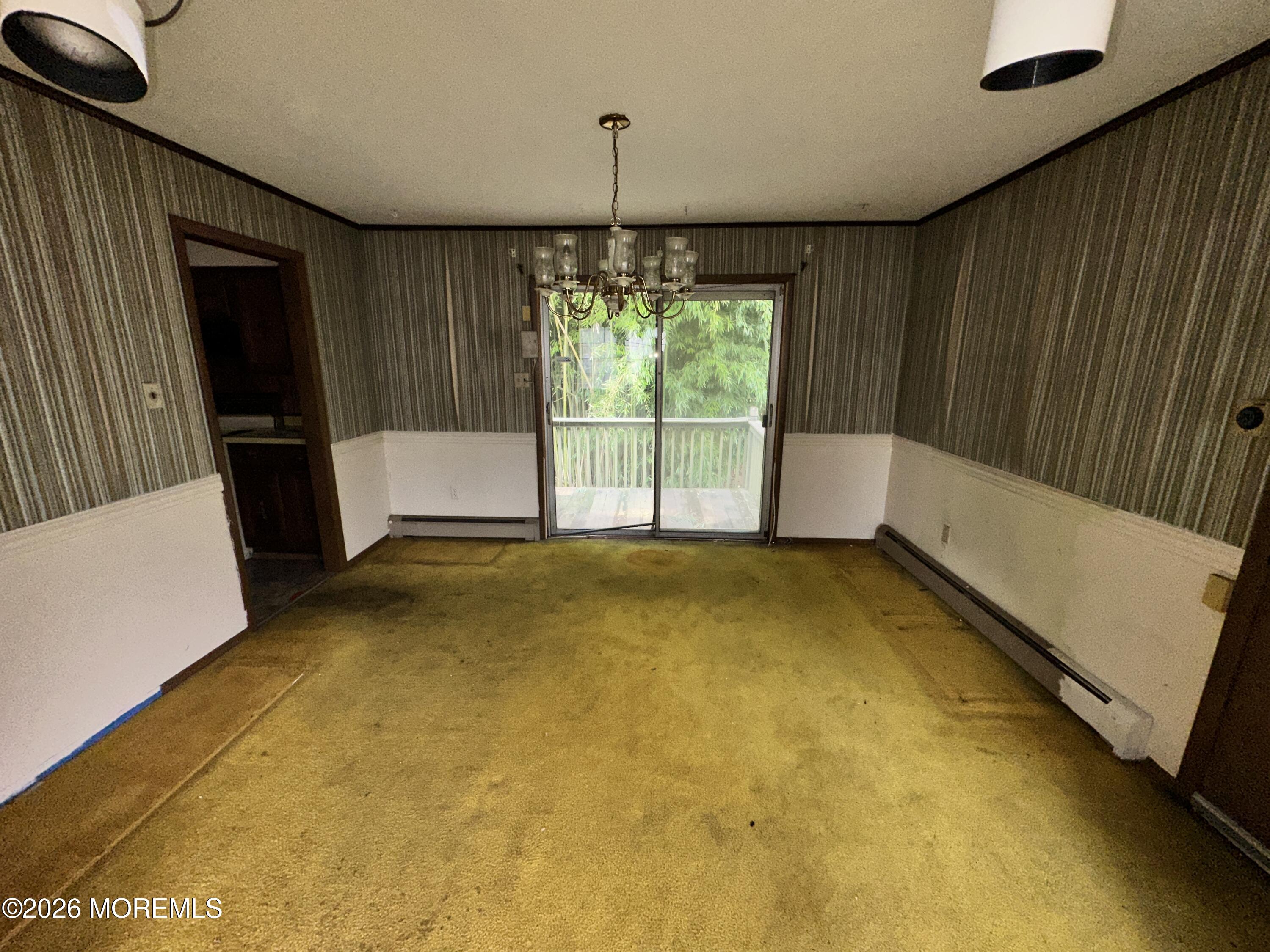 1894 West 4th Street Dunellen, NJ 08812 - Photo 4 of 23 a view of an empty room with a fireplace and a window