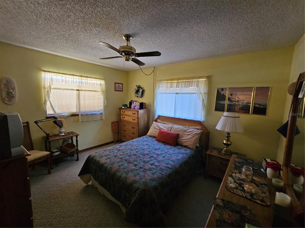 9115 Southwest 102nd Lane Ocala, FL 34481 - Photo 18 of 30 a bedroom with a bed and wooden floor