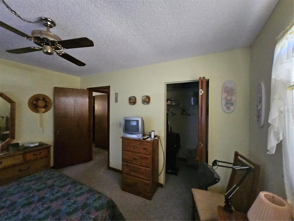 9115 Southwest 102nd Lane Ocala, FL 34481 - Photo 20 of 30 a bedroom with a bed and furniture