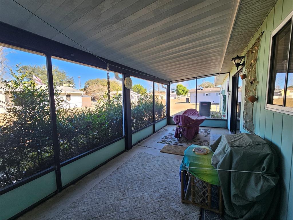 9115 Southwest 102nd Lane Ocala, FL 34481 - Photo 22 of 30 a living room with furniture and a floor to ceiling window