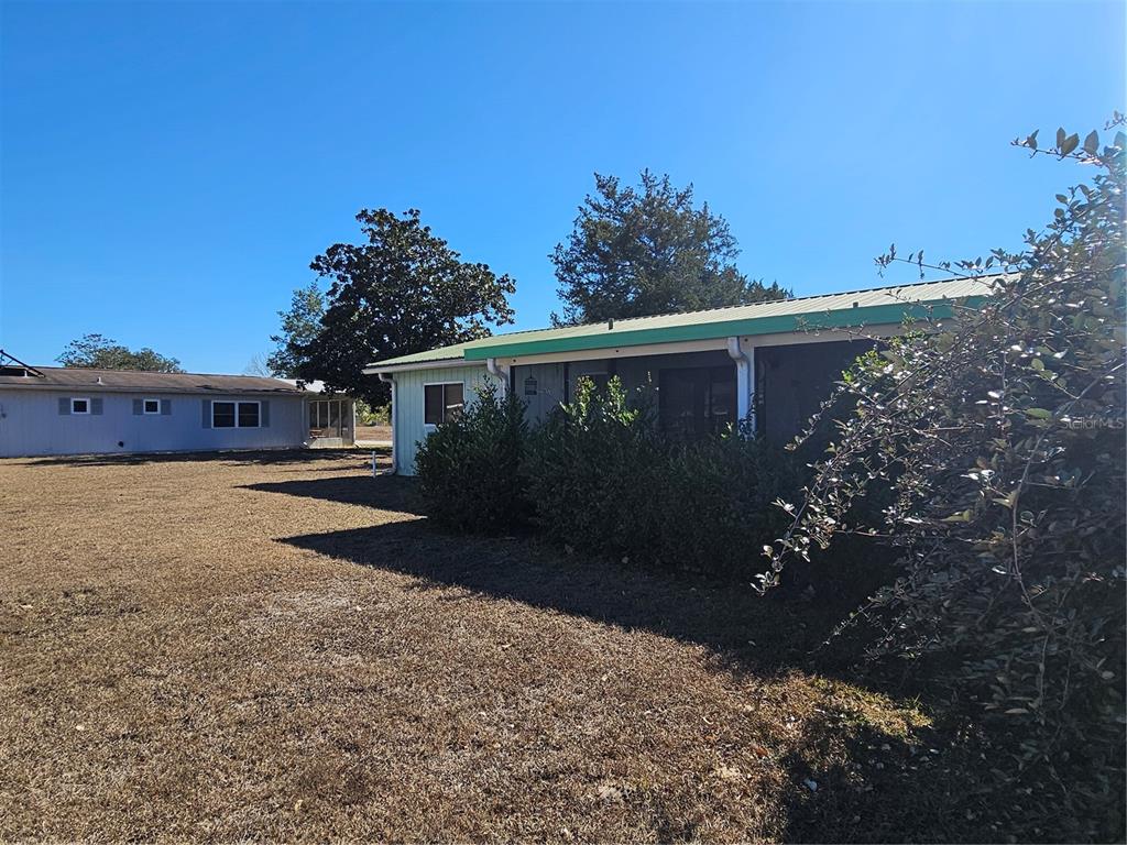 9115 Southwest 102nd Lane Ocala, FL 34481 - Photo 27 of 30 a front view of house with yard and trees in the background