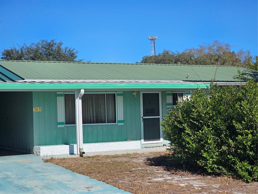 9115 Southwest 102nd Lane Ocala, FL 34481 - Photo 3 of 30 a front view of a house with a yard and garage