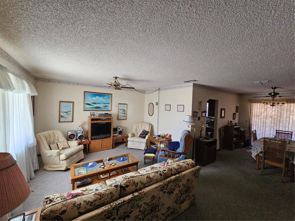 9115 Southwest 102nd Lane Ocala, FL 34481 - Photo 7 of 30 a living room with furniture and a flat screen tv