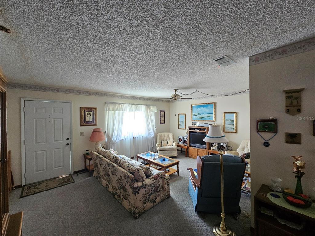 9115 Southwest 102nd Lane Ocala, FL 34481 - Photo 8 of 30 a living room with furniture and a window