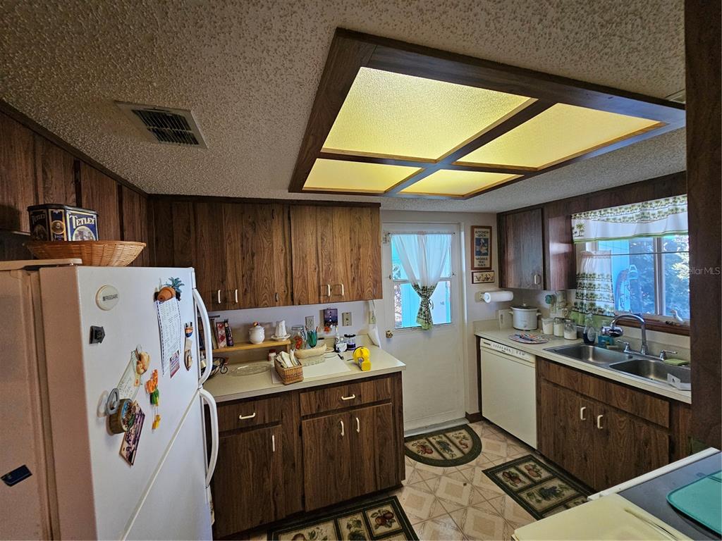 9115 Southwest 102nd Lane Ocala, FL 34481 - Photo 9 of 30 a kitchen with stainless steel appliances granite countertop a refrigerator and a stove