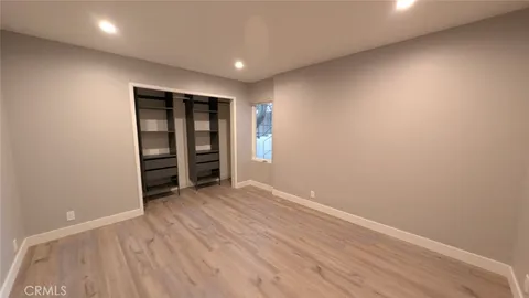 an empty room with closet and a window
