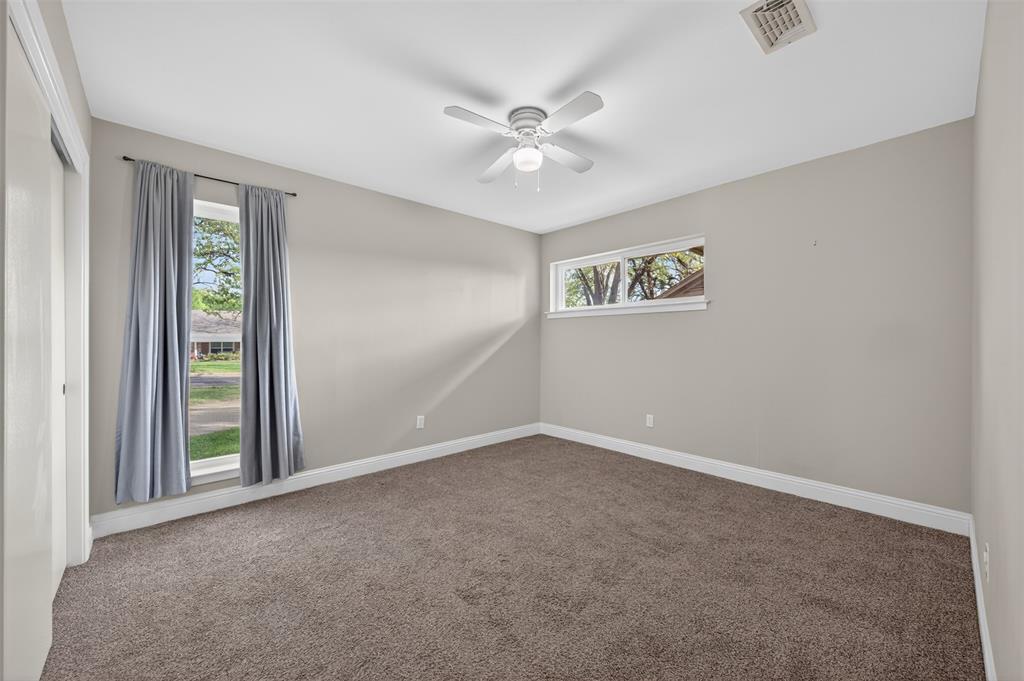 5008 Marble Falls Road Fort Worth, TX 76103 - Photo 15 of 33 an empty room with windows and fan