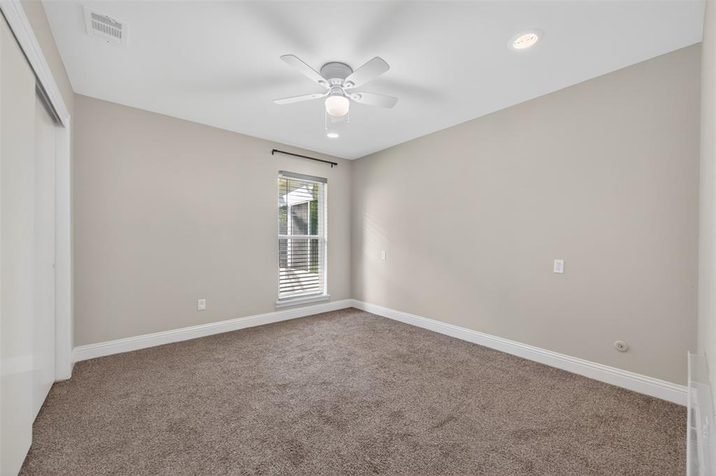 5008 Marble Falls Road Fort Worth, TX 76103 - Photo 17 of 33 an empty room with windows and chandelier fan