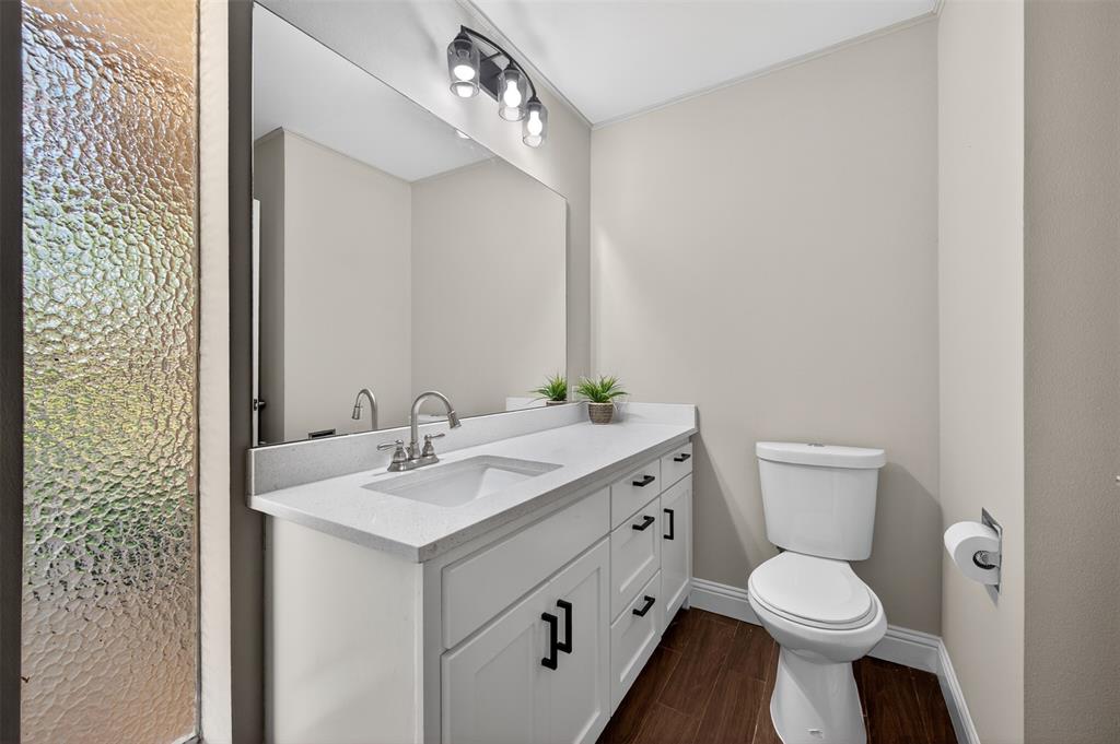 5008 Marble Falls Road Fort Worth, TX 76103 - Photo 19 of 33 a bathroom with a toilet sink and mirror