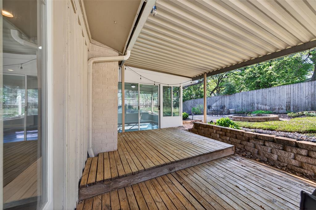 5008 Marble Falls Road Fort Worth, TX 76103 - Photo 22 of 33 a view of a backyard with a wooden deck and furniture