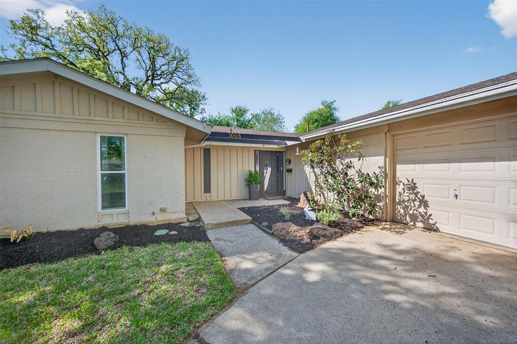5008 Marble Falls Road Fort Worth, TX 76103 - Photo 3 of 33 a front view of a house with garden