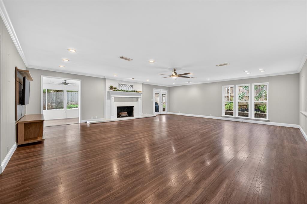 5008 Marble Falls Road Fort Worth, TX 76103 - Photo 33 of 33 an empty room with wooden floor and fireplace