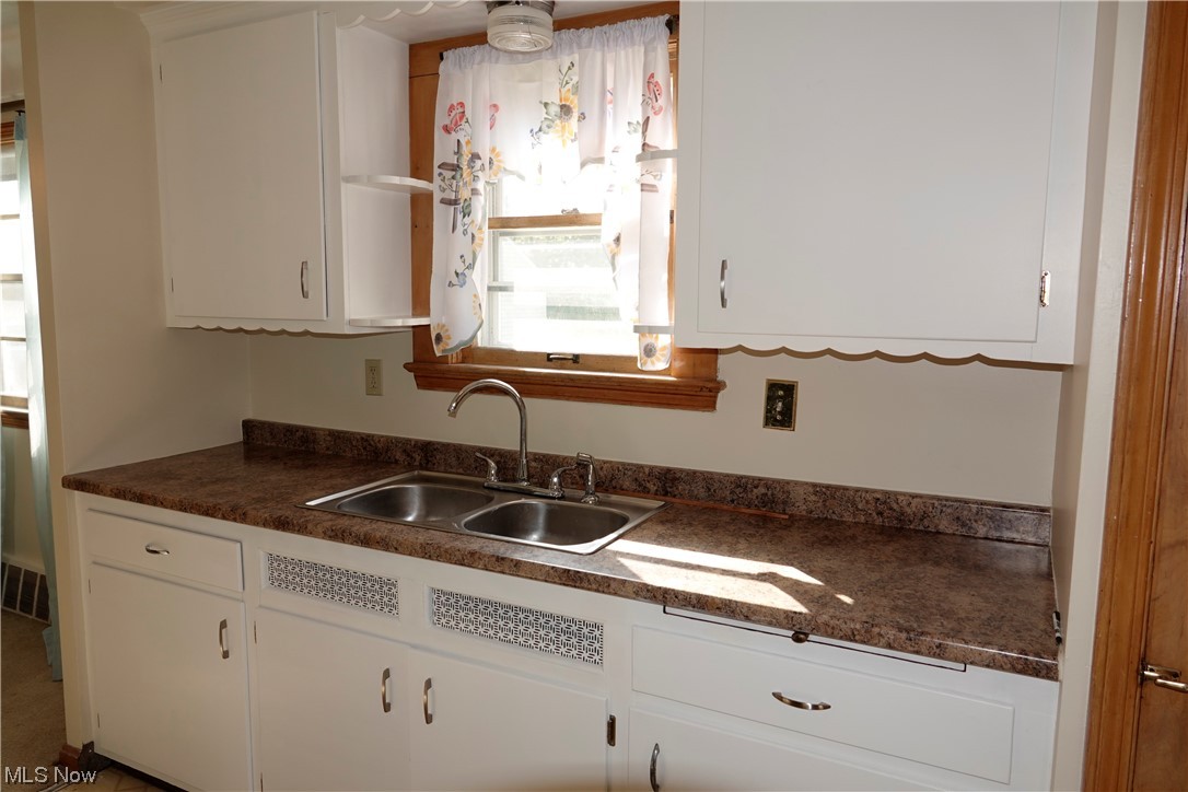 5376 Huron Road Cleveland, OH 44124 - Photo 12 of 32 Kitchen featuring white cabinetry and sink