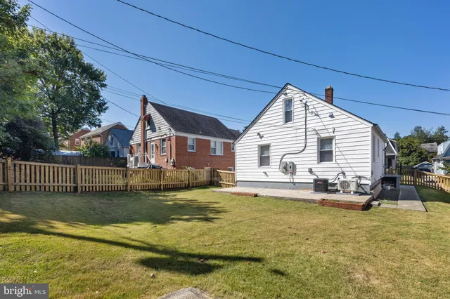 a view of a house with a swimming pool and sitting area