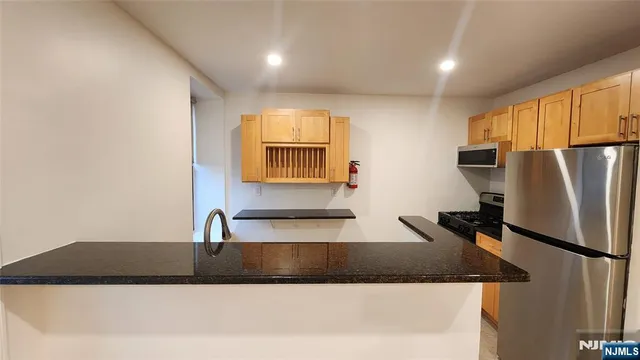 a kitchen that has a sink and a stove in it