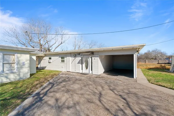 a view of an empty room with a yard and garage