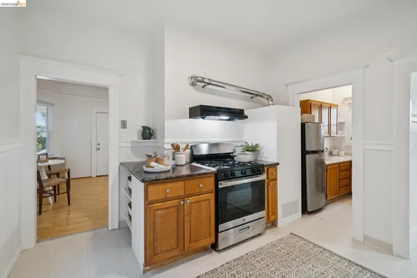 a kitchen with stainless steel appliances granite countertop a stove and a refrigerator
