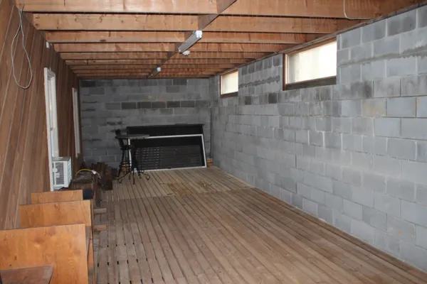 a view of a porch with wooden floor and fence