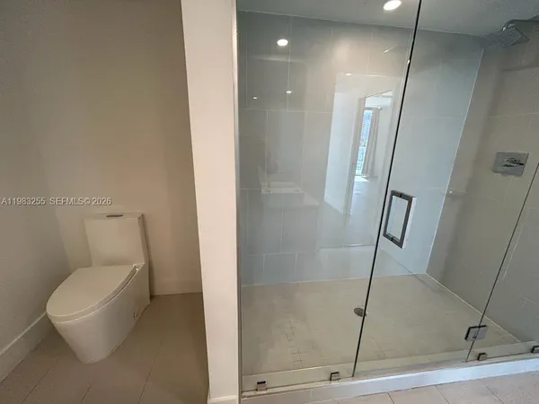a bathroom with a sink a toilet and a shower