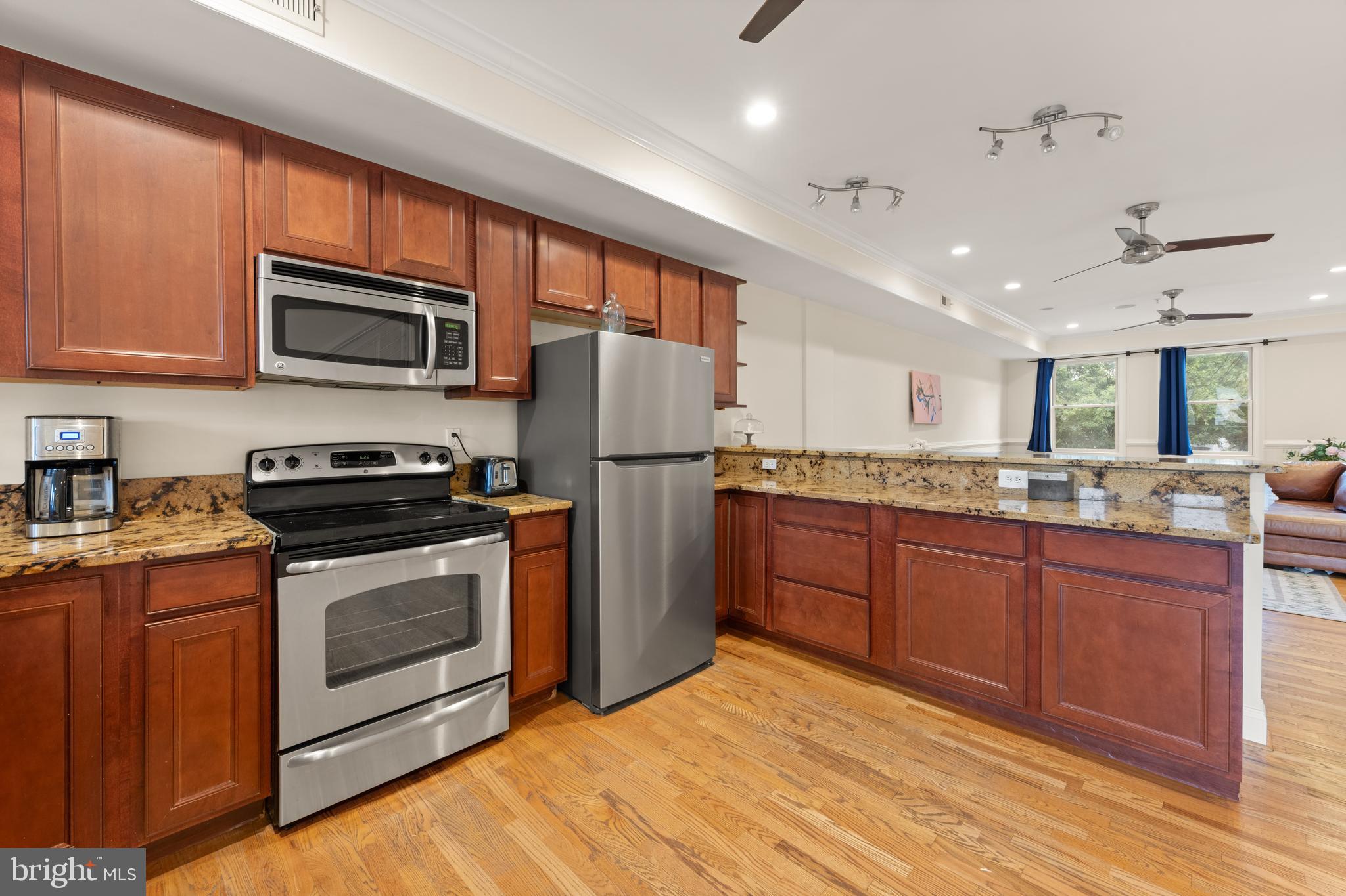 1645 New Jersey Avenue Northwest, Unit 2 Washington, DC 20001 - Photo 14 of 49 a kitchen with stainless steel appliances granite countertop a stove a sink dishwasher a refrigerator and a microwave oven with cabinets