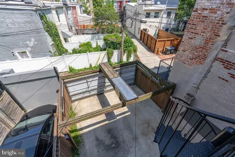 a city view from a balcony with outdoor seating