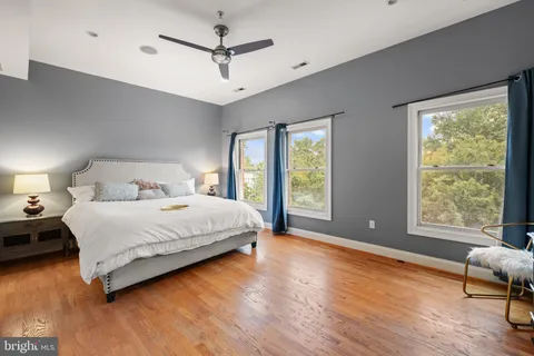 a bedroom with a bed and large window