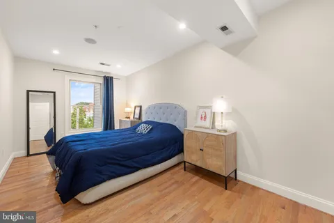 a bedroom with a bed and a dresser